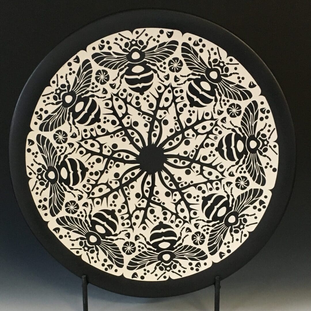 A black and white plate with bees on it