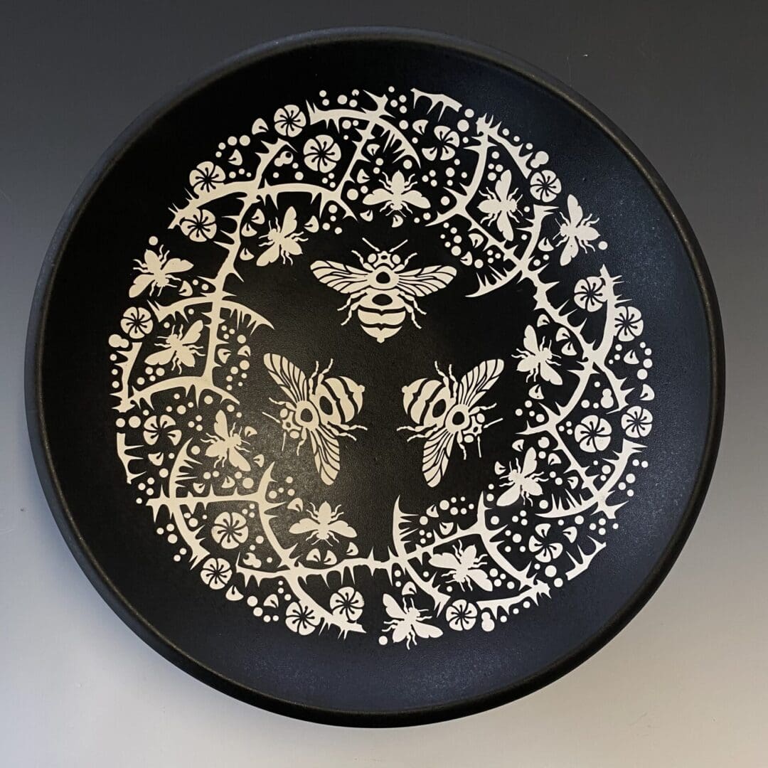 A black plate with white designs on it