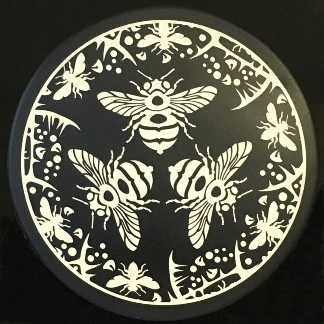 A black and white picture of a bee design.