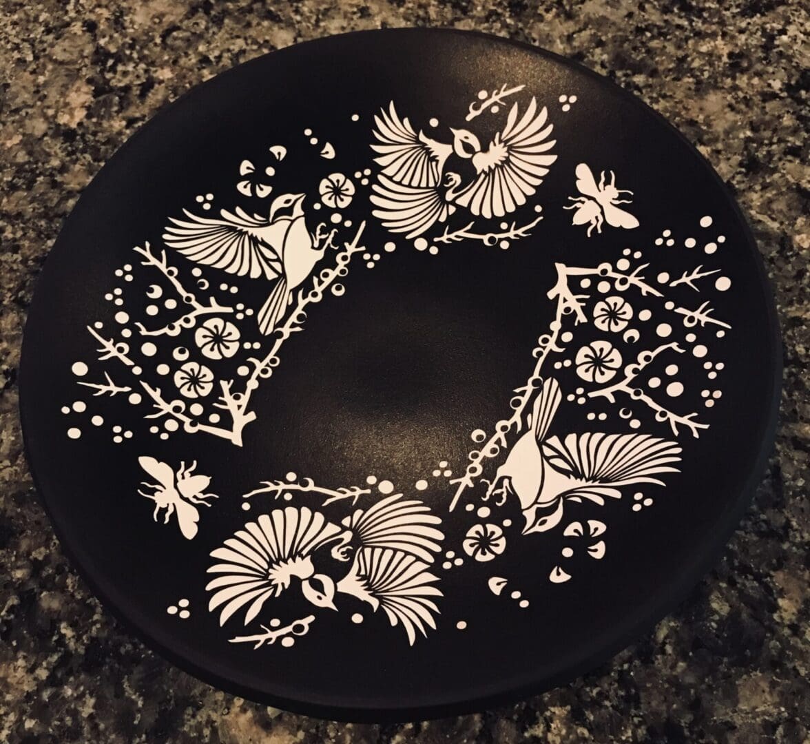 A black plate with white designs on it