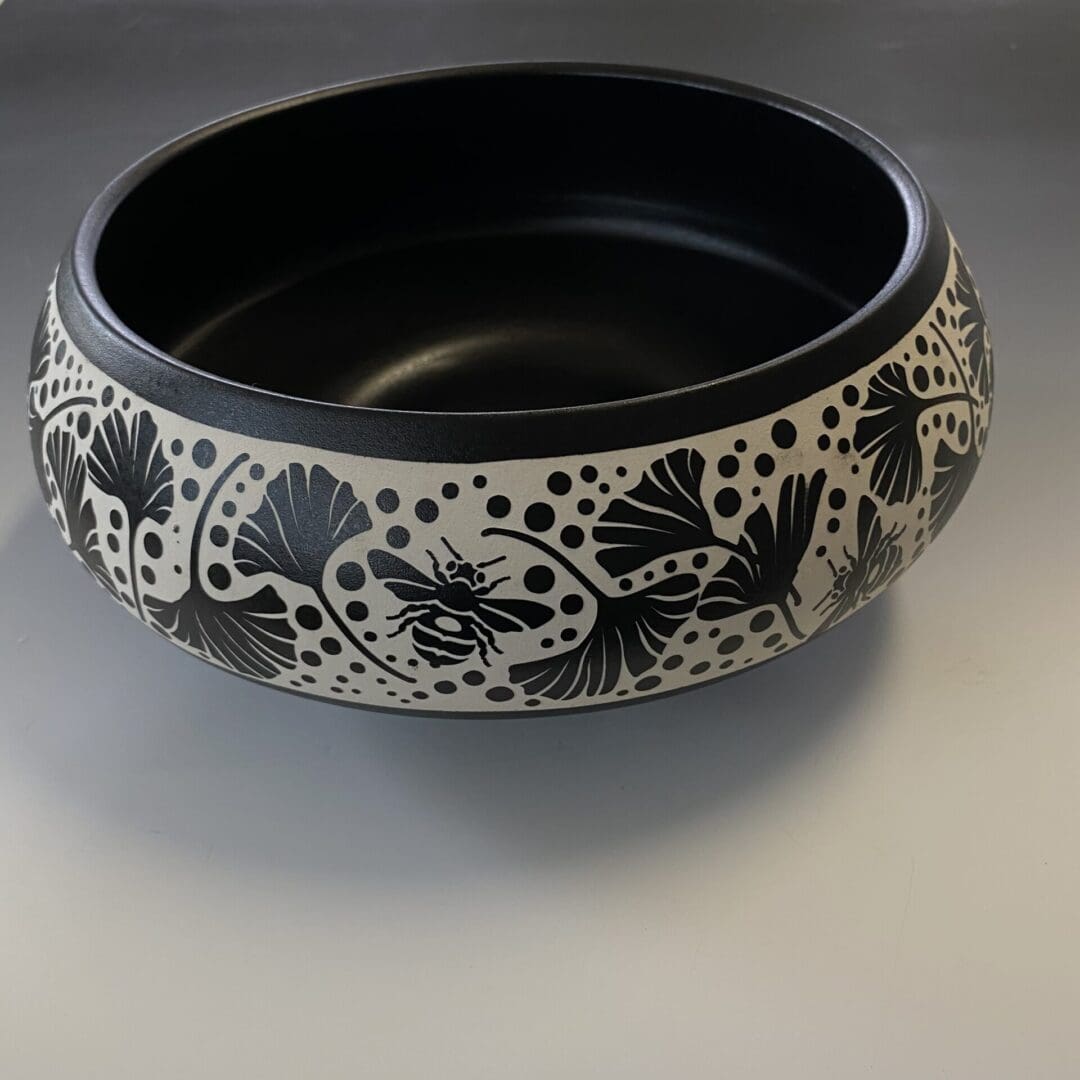 A bowl with black and white designs on it.