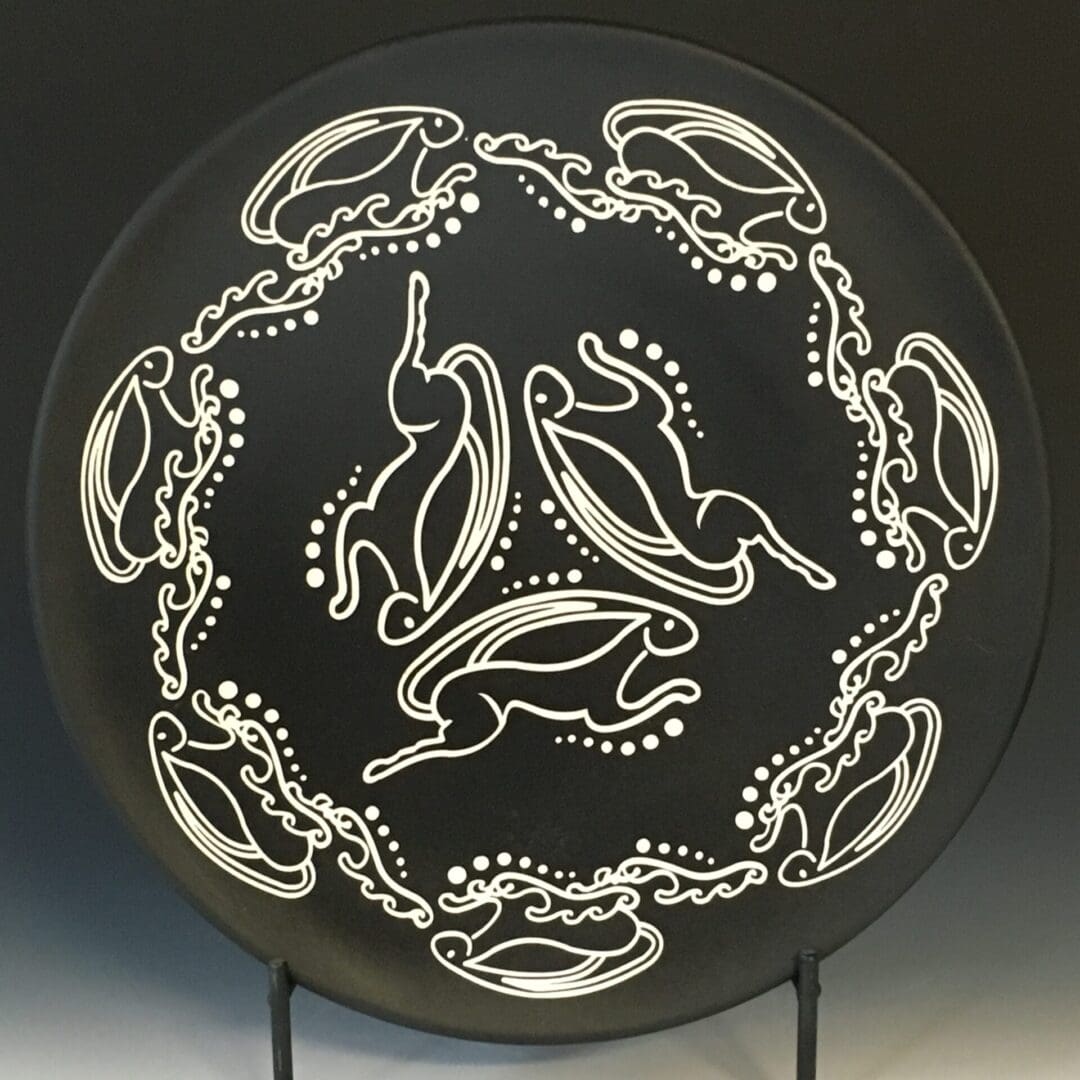 A black plate with white designs on it