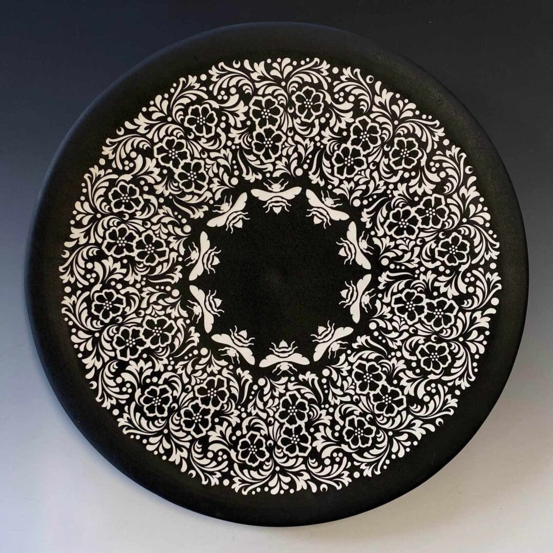 A black and white plate with a floral design.